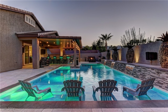 view of pool with a pergola, a patio area, and pool water feature