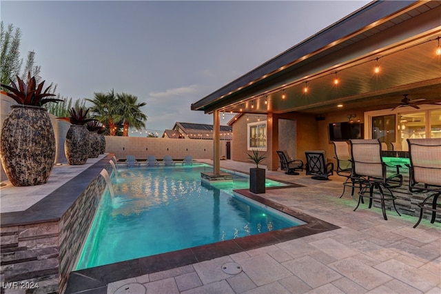 view of pool with ceiling fan, a patio, and pool water feature