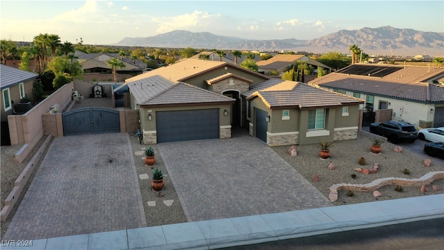 view of front of property with a mountain view and a garage