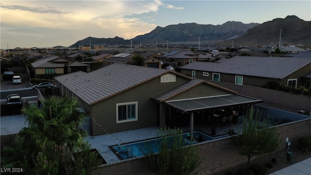 aerial view at dusk featuring a mountain view