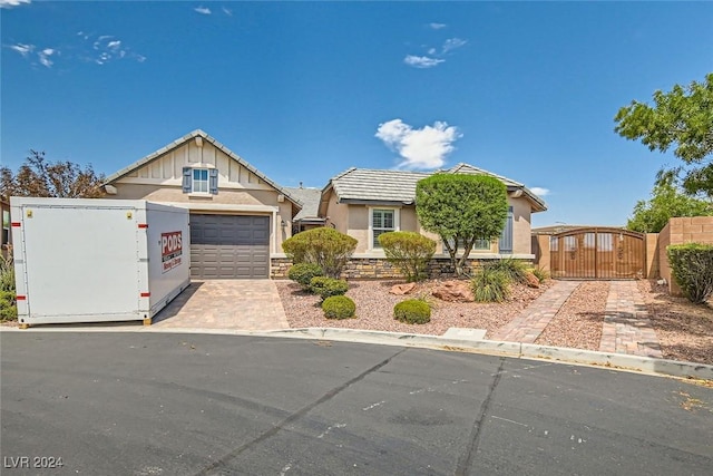 view of front of home featuring central AC unit and a garage