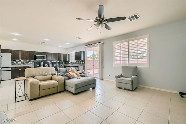 tiled living room with ceiling fan