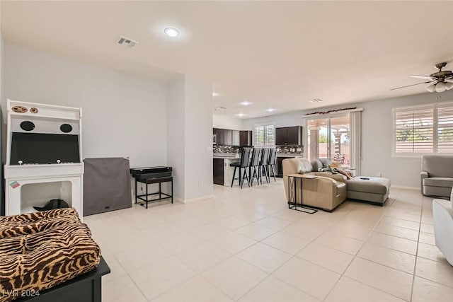 living room with light tile patterned floors and ceiling fan