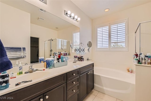 bathroom with plus walk in shower, tile patterned floors, and vanity