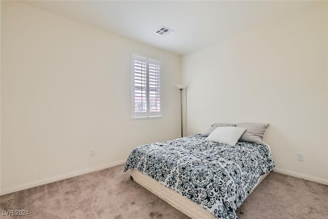 bedroom with light colored carpet