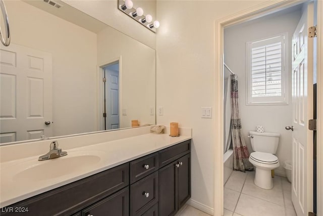 full bathroom featuring vanity, toilet, tile patterned flooring, and shower / tub combo