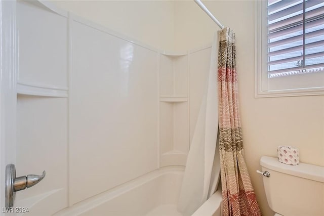 bathroom with shower / bath combo and toilet