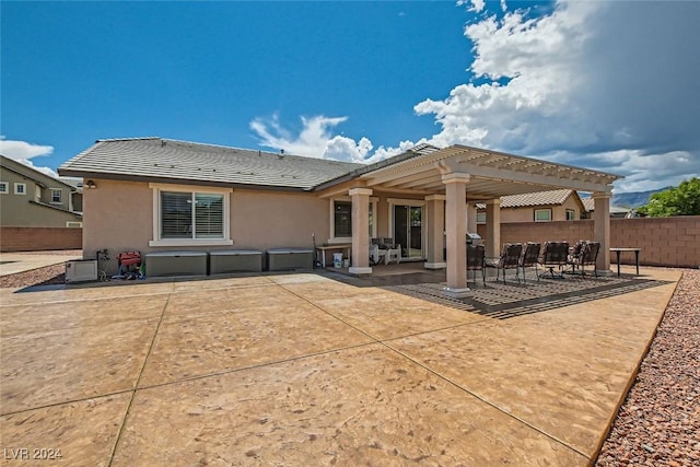 rear view of house with a patio area and a pergola