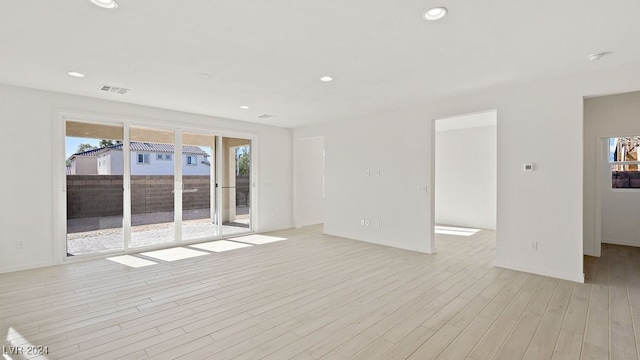 empty room featuring recessed lighting, visible vents, and light wood-style flooring