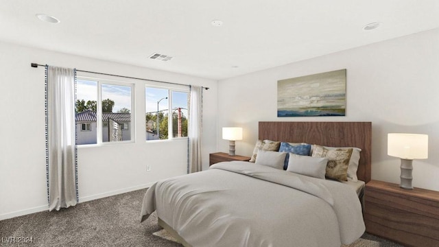 carpeted bedroom with visible vents and baseboards