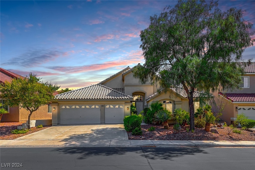 mediterranean / spanish house featuring a garage