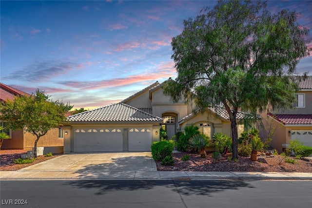 mediterranean / spanish house featuring a garage