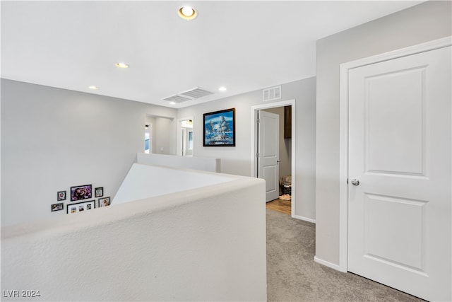 corridor with light colored carpet