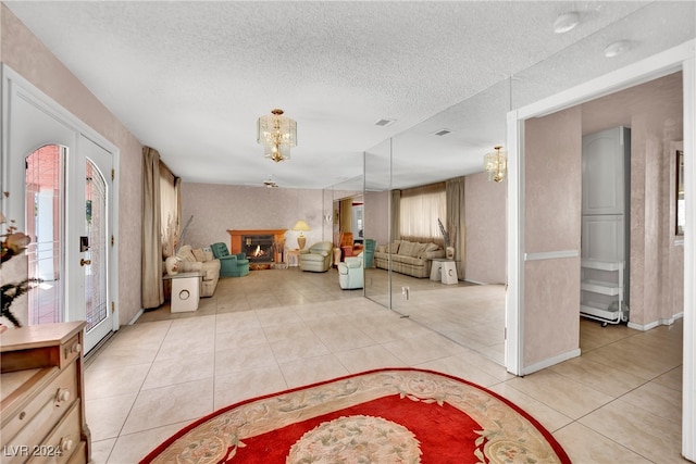 tiled entryway featuring a textured ceiling