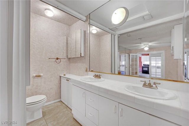 bathroom featuring ceiling fan, tile patterned floors, dual bowl vanity, and toilet