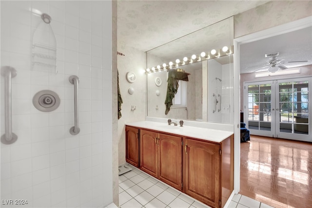 bathroom with ceiling fan, french doors, tile patterned floors, and vanity