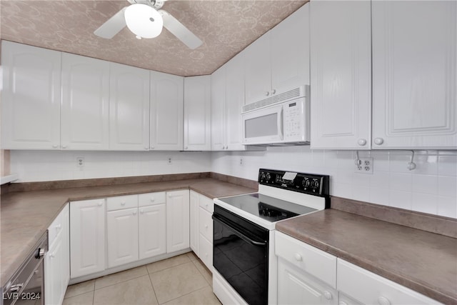 kitchen with ceiling fan, white cabinetry, light tile patterned floors, backsplash, and white appliances