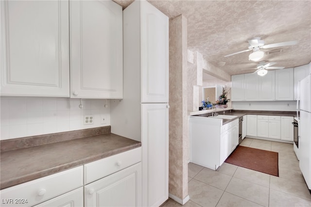 kitchen featuring tasteful backsplash, a textured ceiling, light tile patterned flooring, ceiling fan, and white cabinets