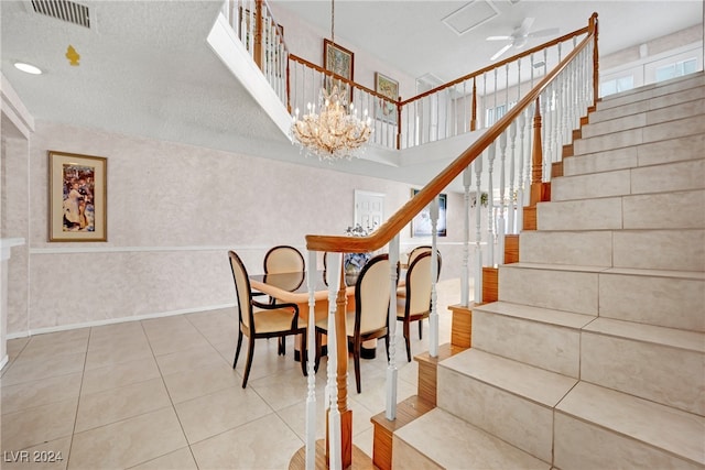 interior space with ceiling fan with notable chandelier, a textured ceiling, and wood-type flooring