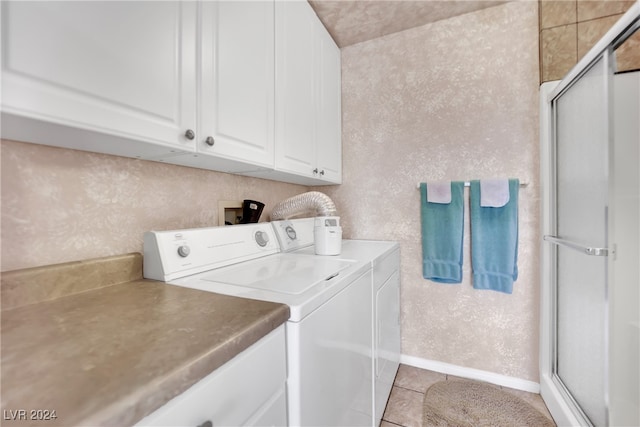 washroom featuring light tile patterned flooring, separate washer and dryer, and cabinets