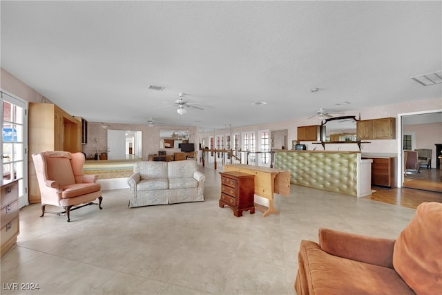 tiled living room featuring ceiling fan