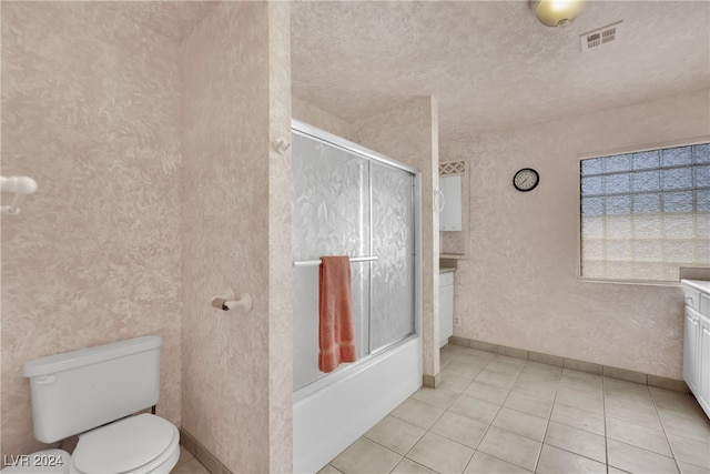 full bathroom with combined bath / shower with glass door, vanity, a textured ceiling, and tile patterned flooring