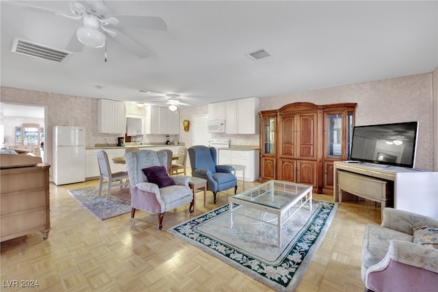 living room with light parquet floors and ceiling fan