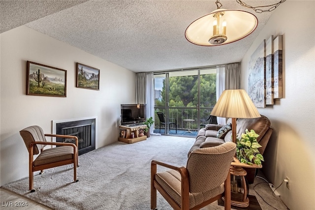 living room with carpet, a textured ceiling, and floor to ceiling windows