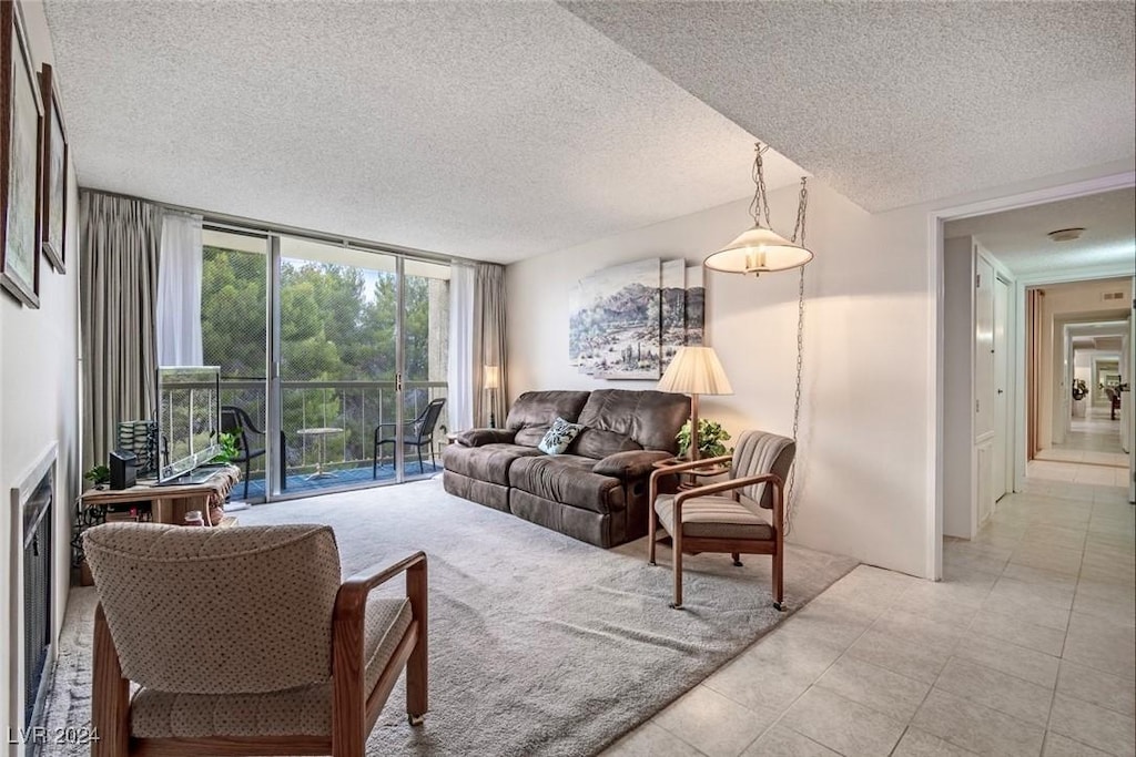 living room featuring light tile patterned flooring and a textured ceiling