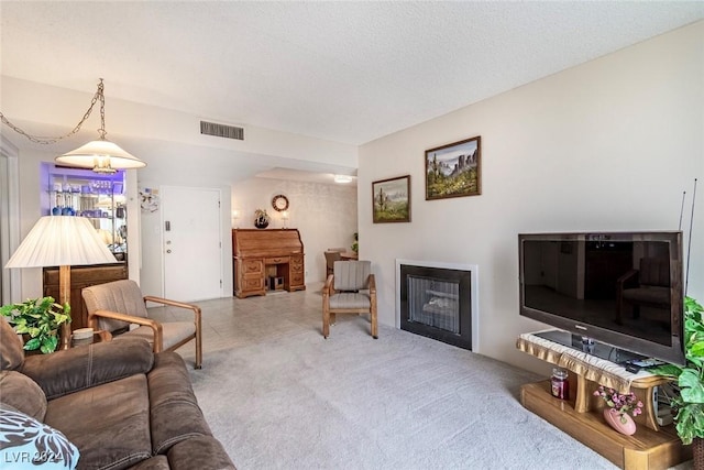 living room featuring light carpet and a textured ceiling