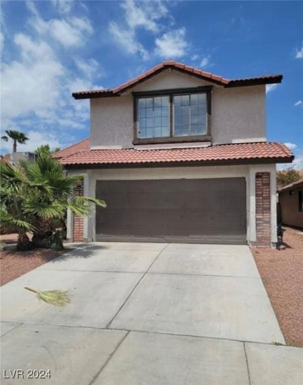 6444 Deadwood Rd, Las Vegas, NV 89108 - view of front facade with stucco siding, driveway, an attached garage, and a tiled roof