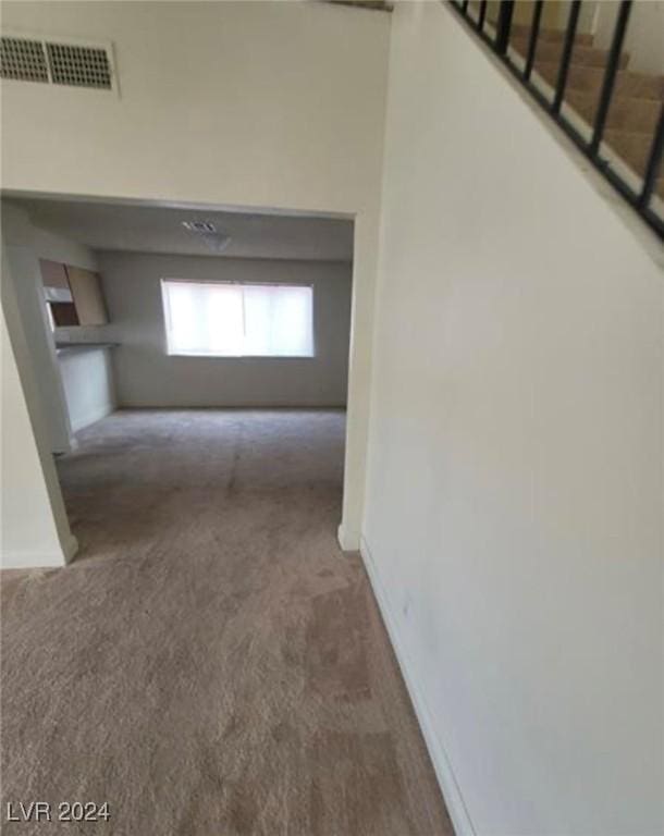 6444 Deadwood Rd, Las Vegas, NV 89108 - hallway with visible vents, carpet flooring, stairway, and baseboards