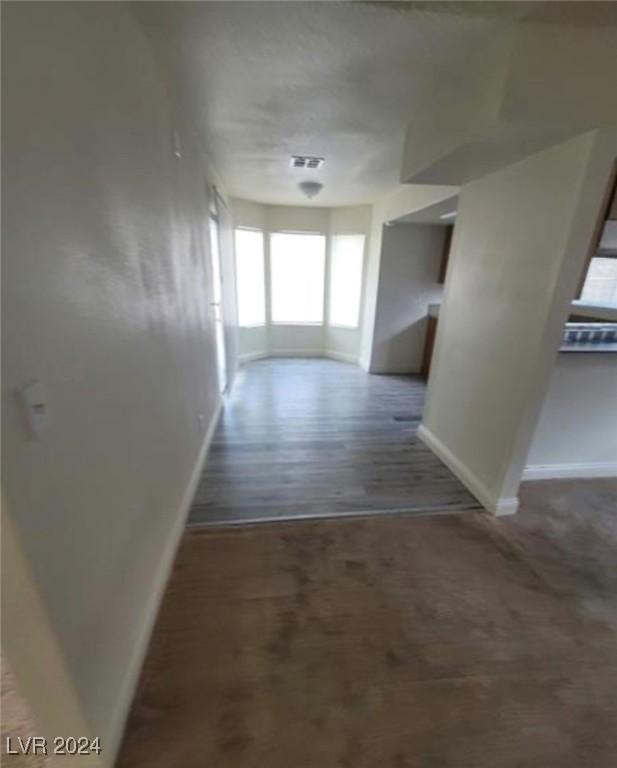 corridor with hardwood / wood-style floors