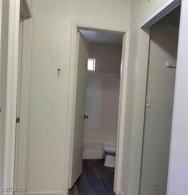 bathroom with hardwood / wood-style flooring and toilet