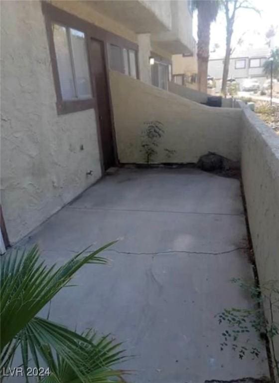 view of patio featuring a balcony