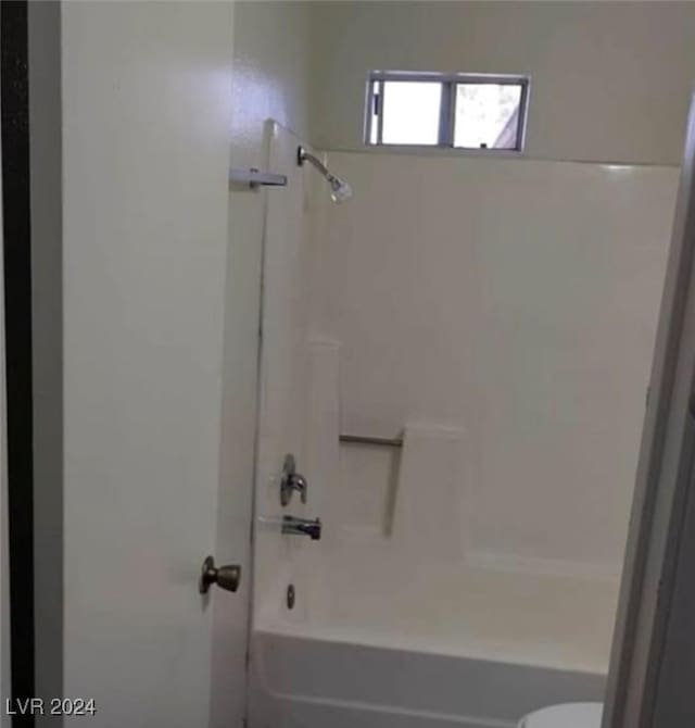 bathroom with toilet and shower / bath combination