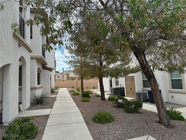 view of yard with a patio area, fence, and central air condition unit