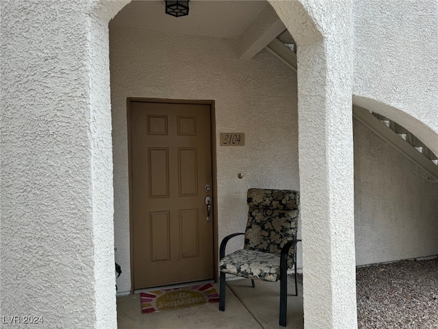 entrance to property featuring stucco siding