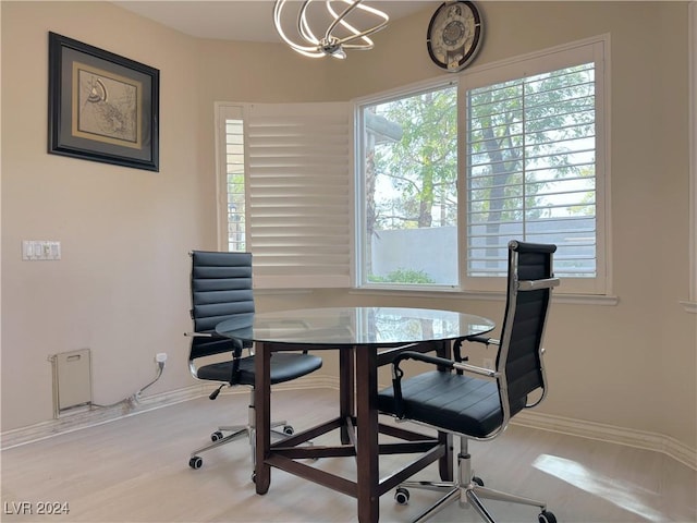 office area with a chandelier, baseboards, and wood finished floors