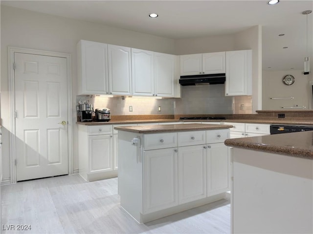 kitchen featuring recessed lighting, decorative backsplash, white cabinets, under cabinet range hood, and dishwashing machine