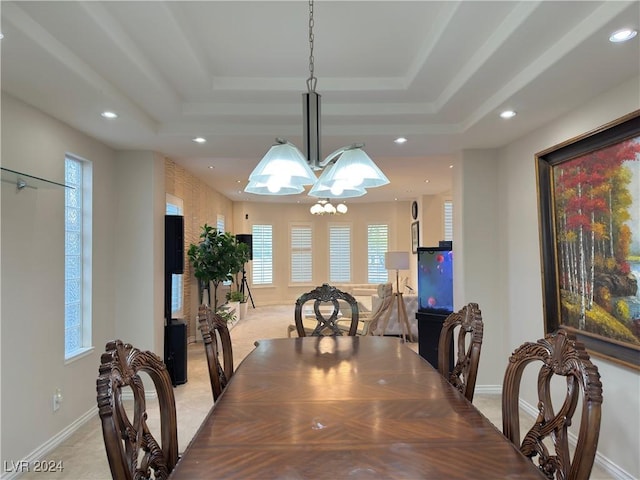 dining space featuring light colored carpet, a raised ceiling, and recessed lighting