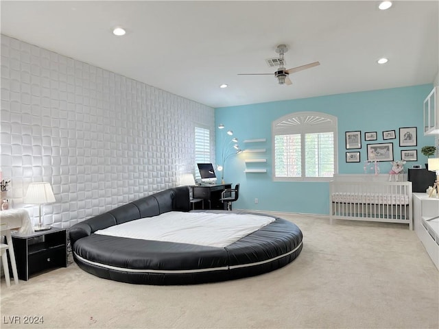 bedroom with an accent wall, recessed lighting, visible vents, and carpet flooring