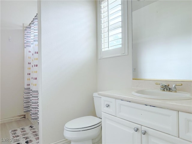 bathroom with a shower with curtain, vanity, toilet, and wood finished floors