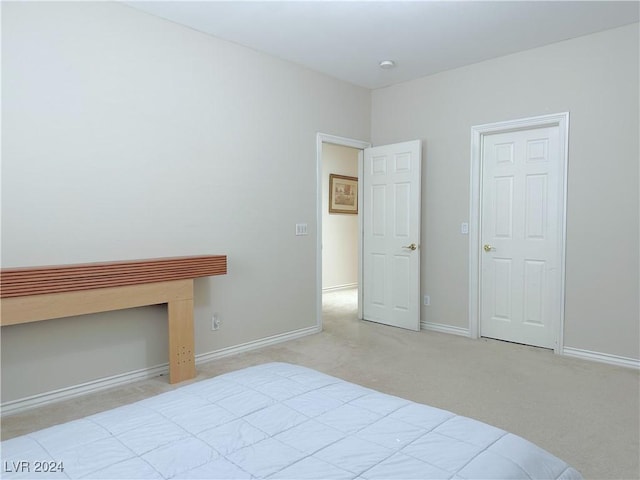 unfurnished bedroom featuring carpet floors and baseboards