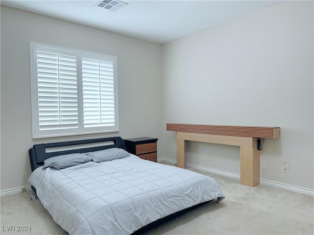 carpeted bedroom featuring visible vents and baseboards