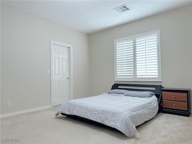 carpeted bedroom with baseboards and visible vents