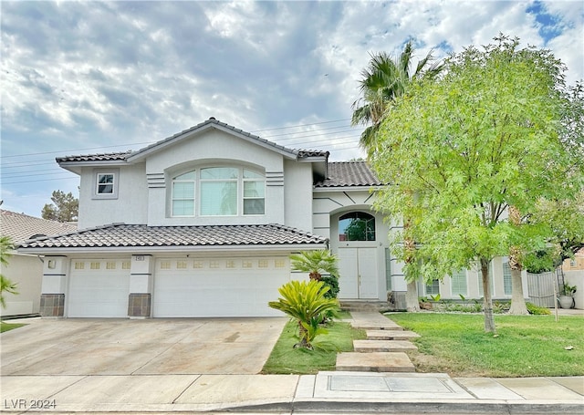 view of front of house featuring a front yard and a garage