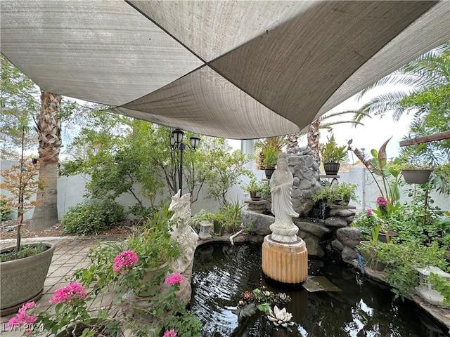 exterior space featuring a garden pond