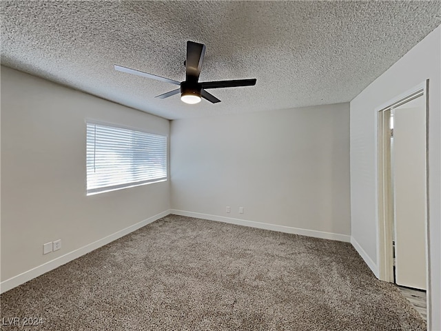 carpeted spare room featuring a textured ceiling and ceiling fan