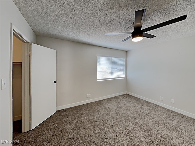 unfurnished room featuring a textured ceiling, ceiling fan, and carpet floors